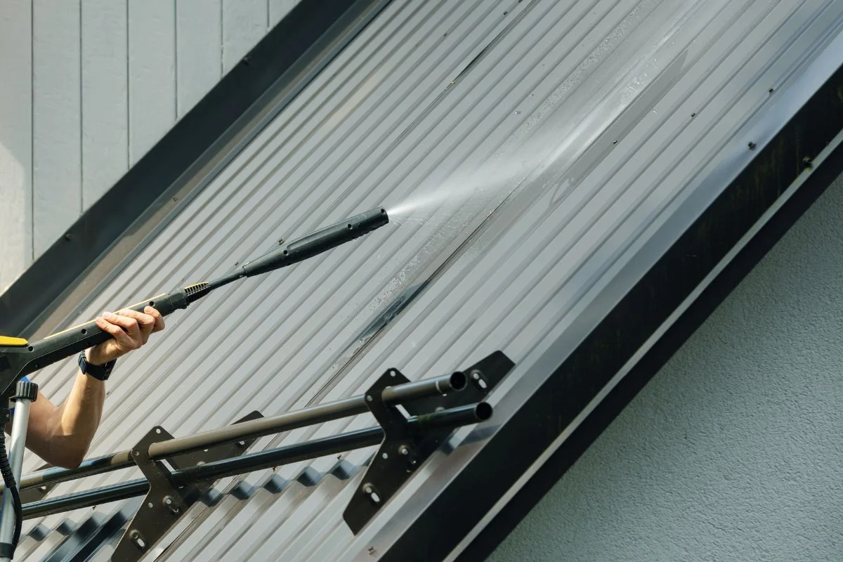 Grey Metal Roof Getting Washed By Roof Cleaner