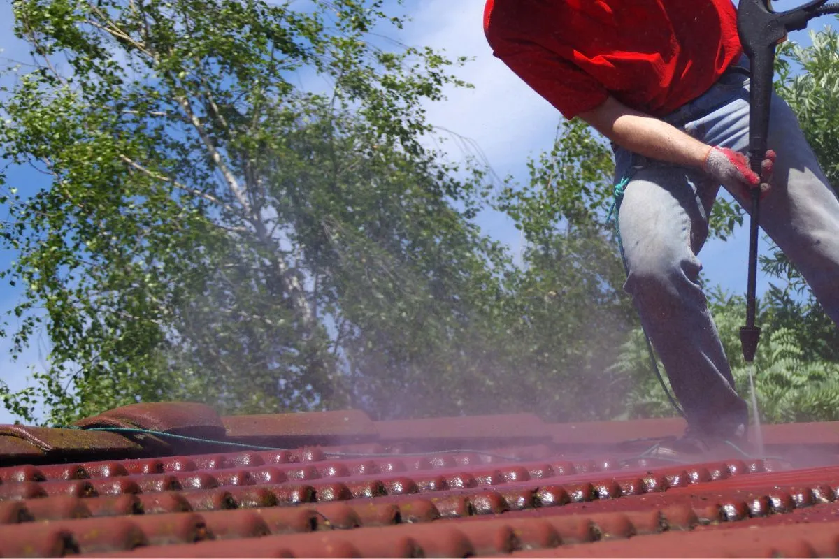 Red Tiled Roof Getting Washed By A Professional Cleaning Contractor